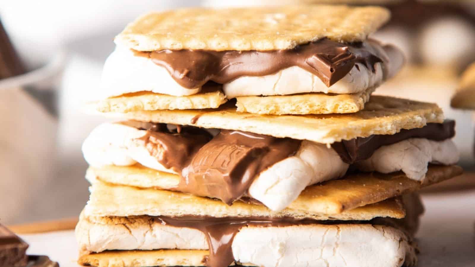 A close-up view of a stack of s'mores, consisting of toasted marshmallows and melted chocolate sandwiched between graham crackers.