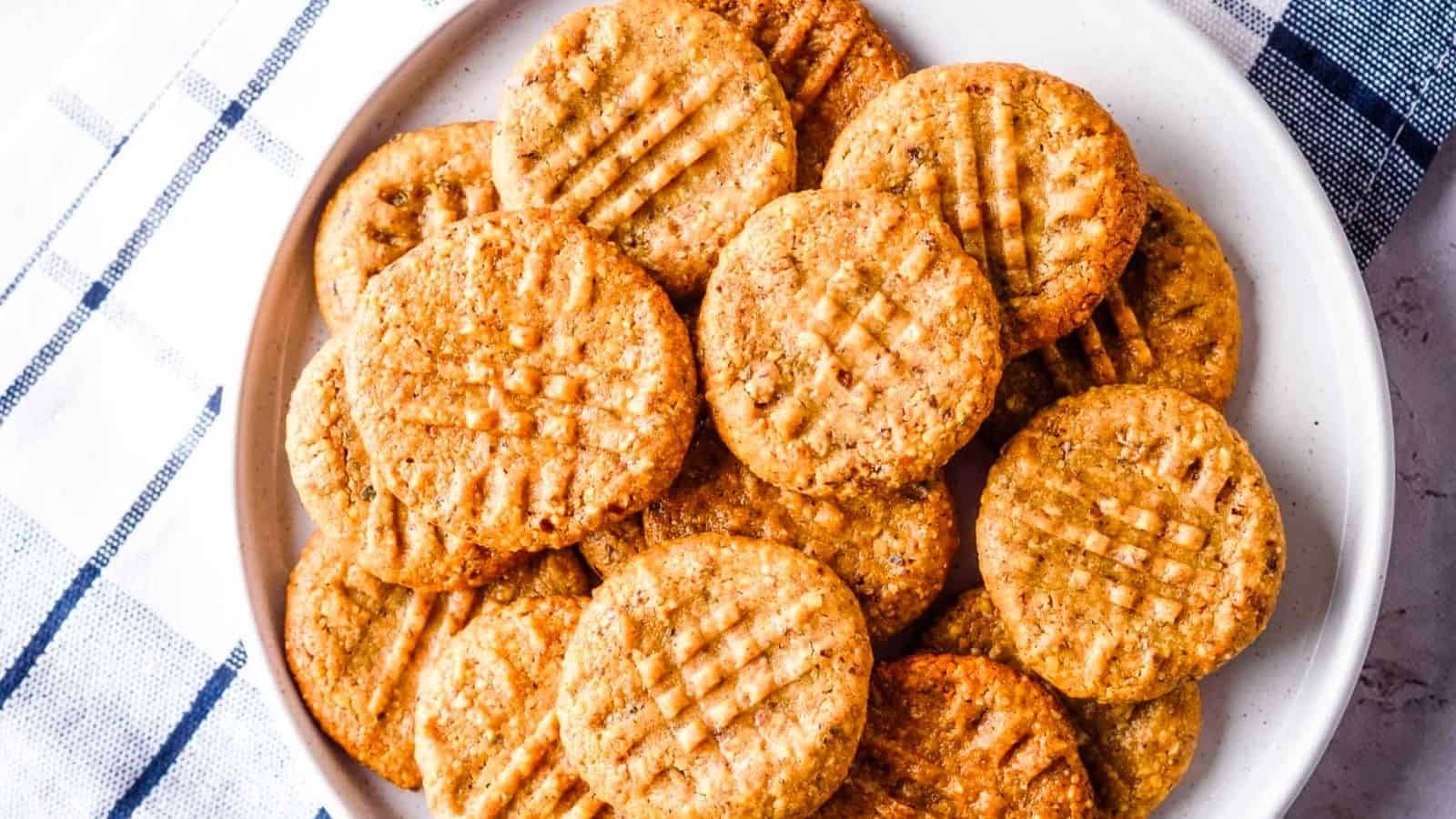 Side angle view of almond flour peanut butter cookies with one half-bitten cookie.