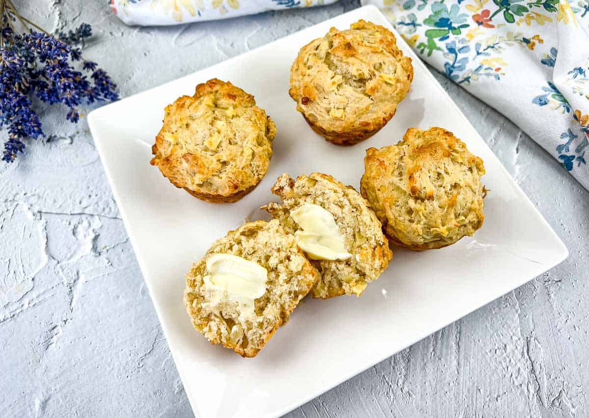 Apple cheddar muffins on a plate.