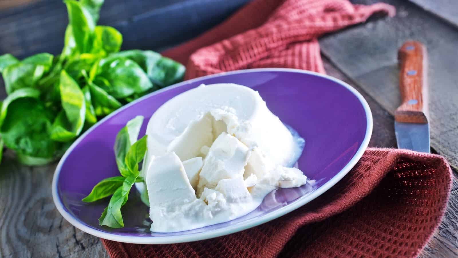 Fresh ricotta with basil on the plate.