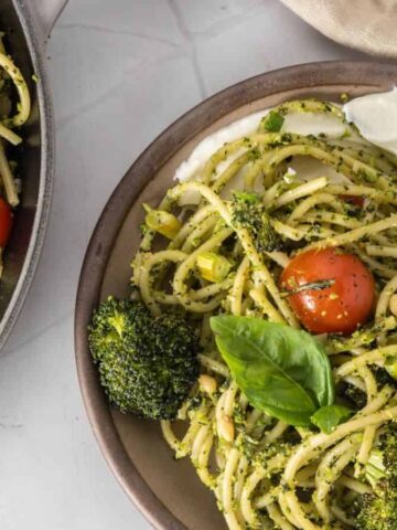 An overhead image of broccoli pesto pasta served in a plate.