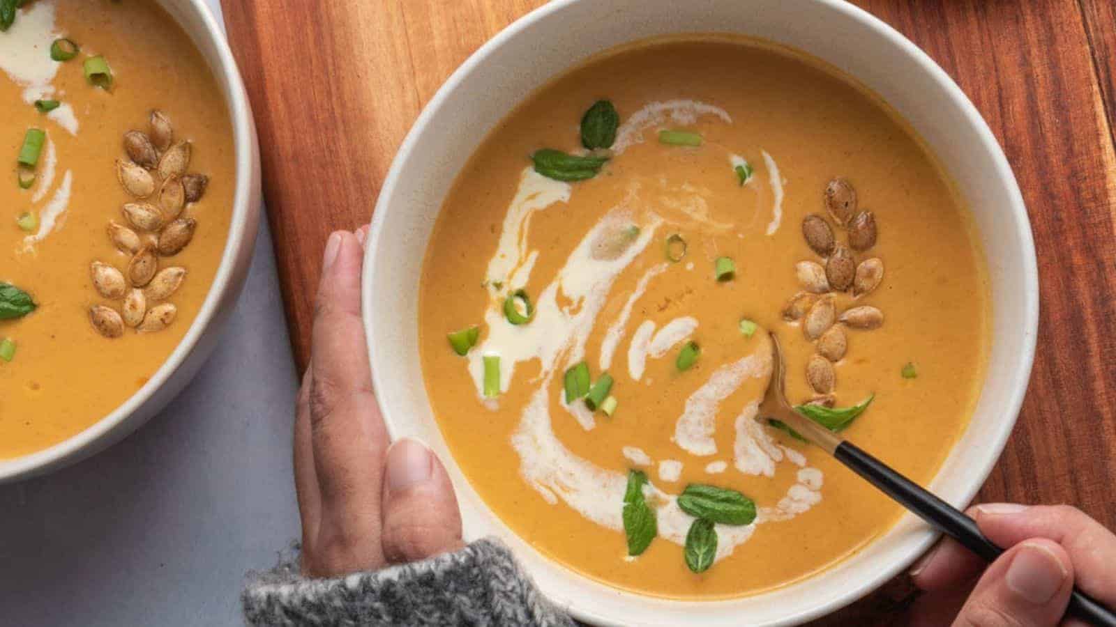 Top view of butternut squash soup with a spoon in it.