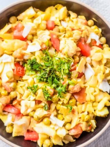 An overhead image of cooked cabbage curry in a round plate.