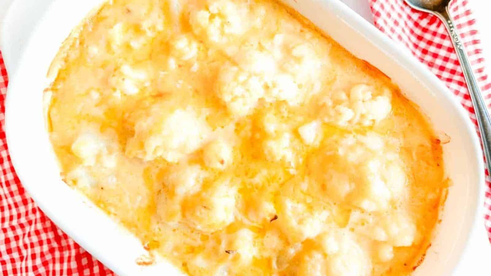 Cheese sauce over cauliflower in a casserole.