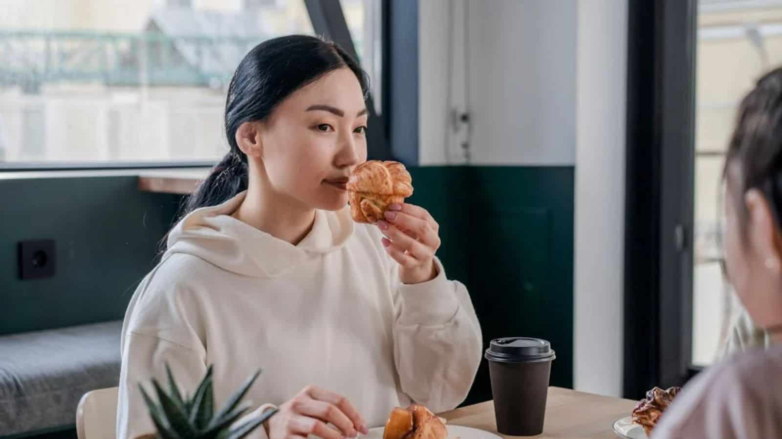 A Woman Smelling a Muffin.