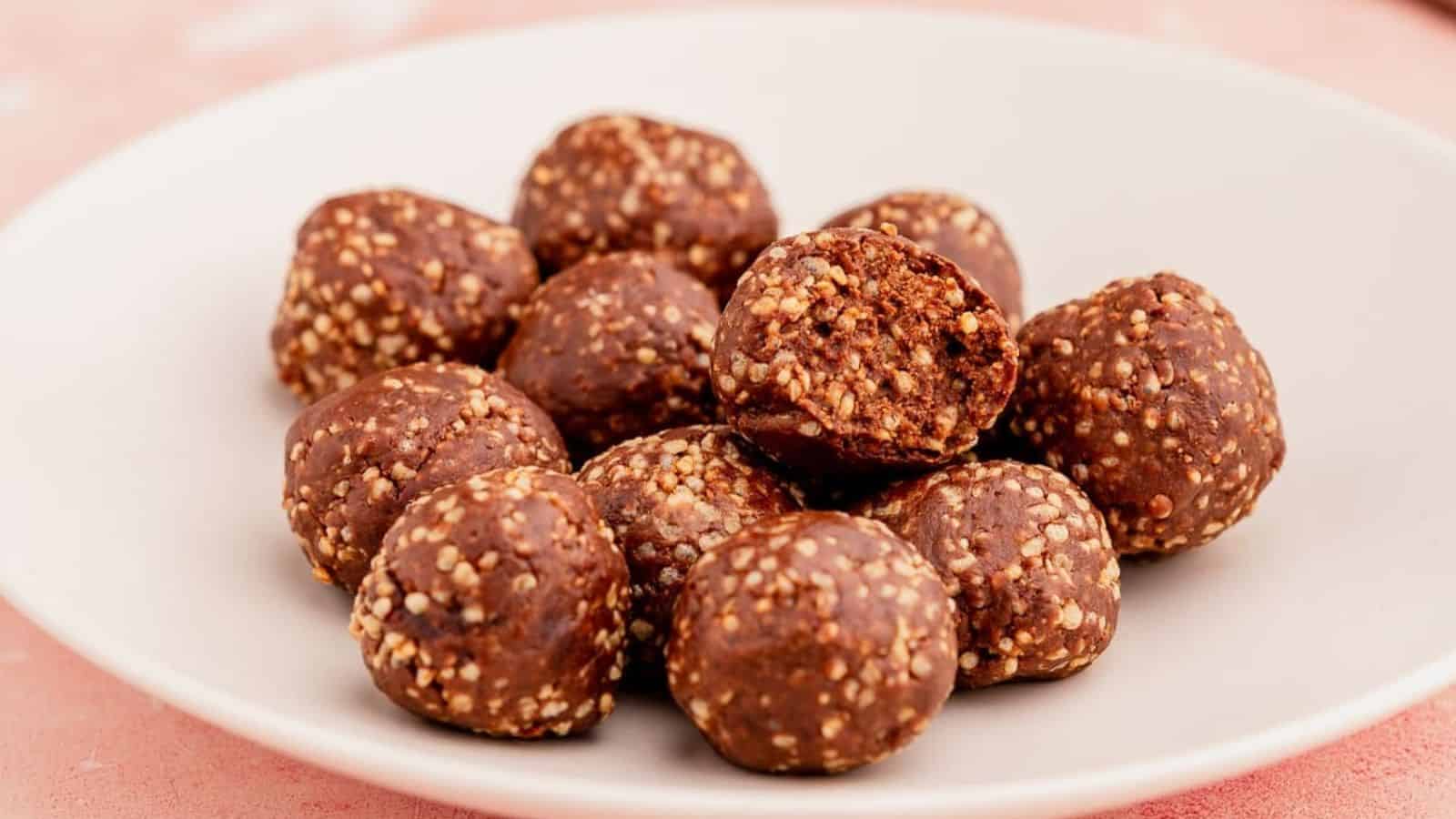A close up image of chocolate peanut butter quinoa crunch bites in a white plate.