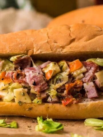 Close-up image of chopped italian sandwich on a wooden surface.