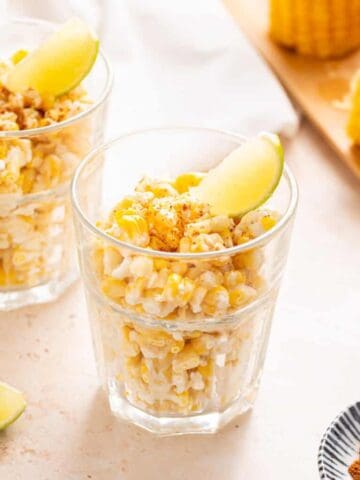 Two glasses of Corn in a Cup garnished with lime.