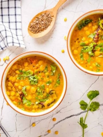 Two bowls of finished dal tadka next to each other.
