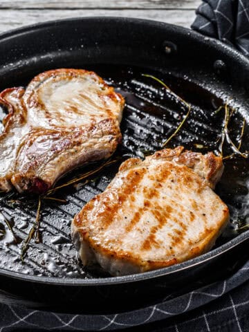 Grilled pork cutlets in a pan.