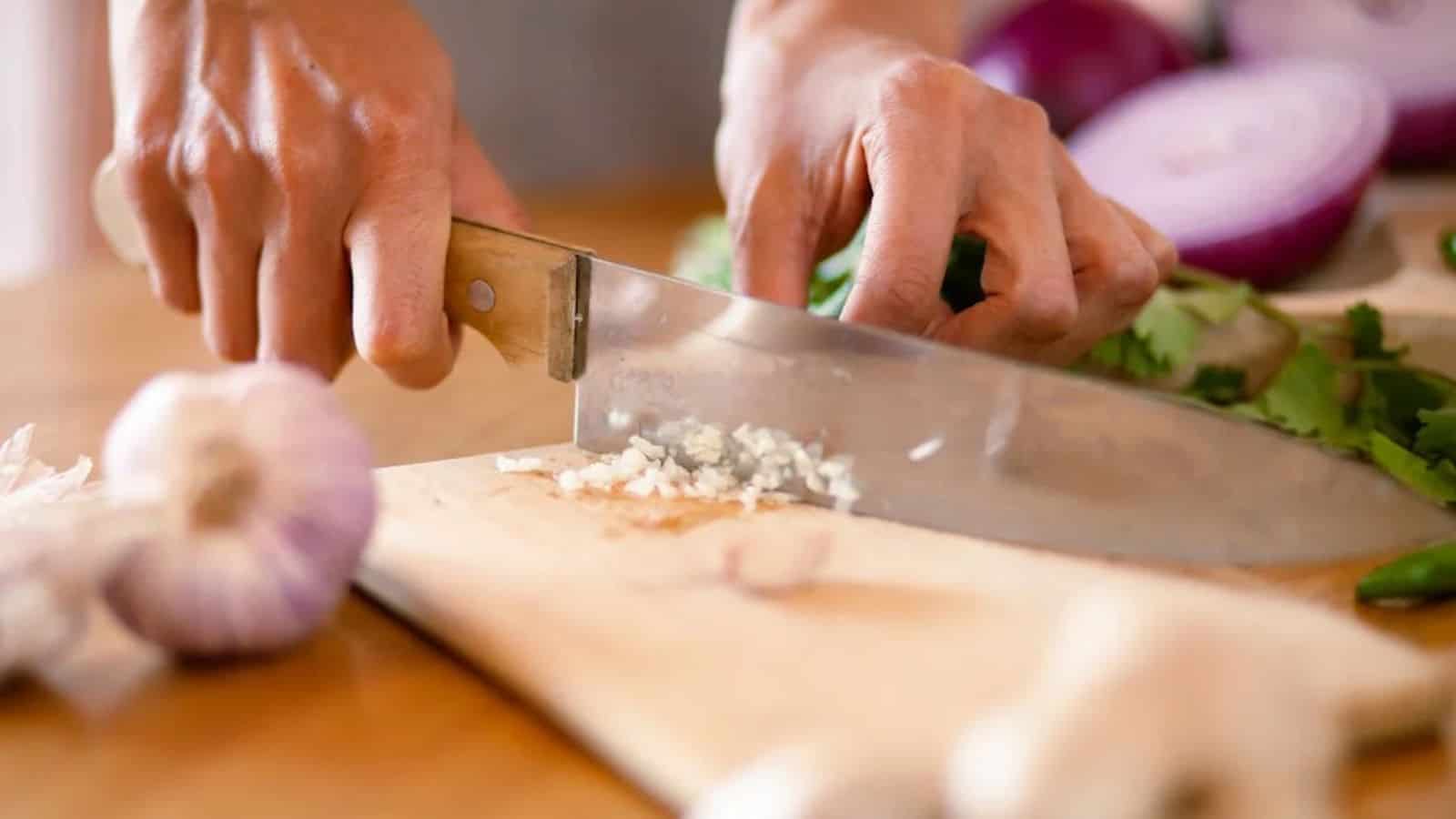 A Person Chopping Garlic.