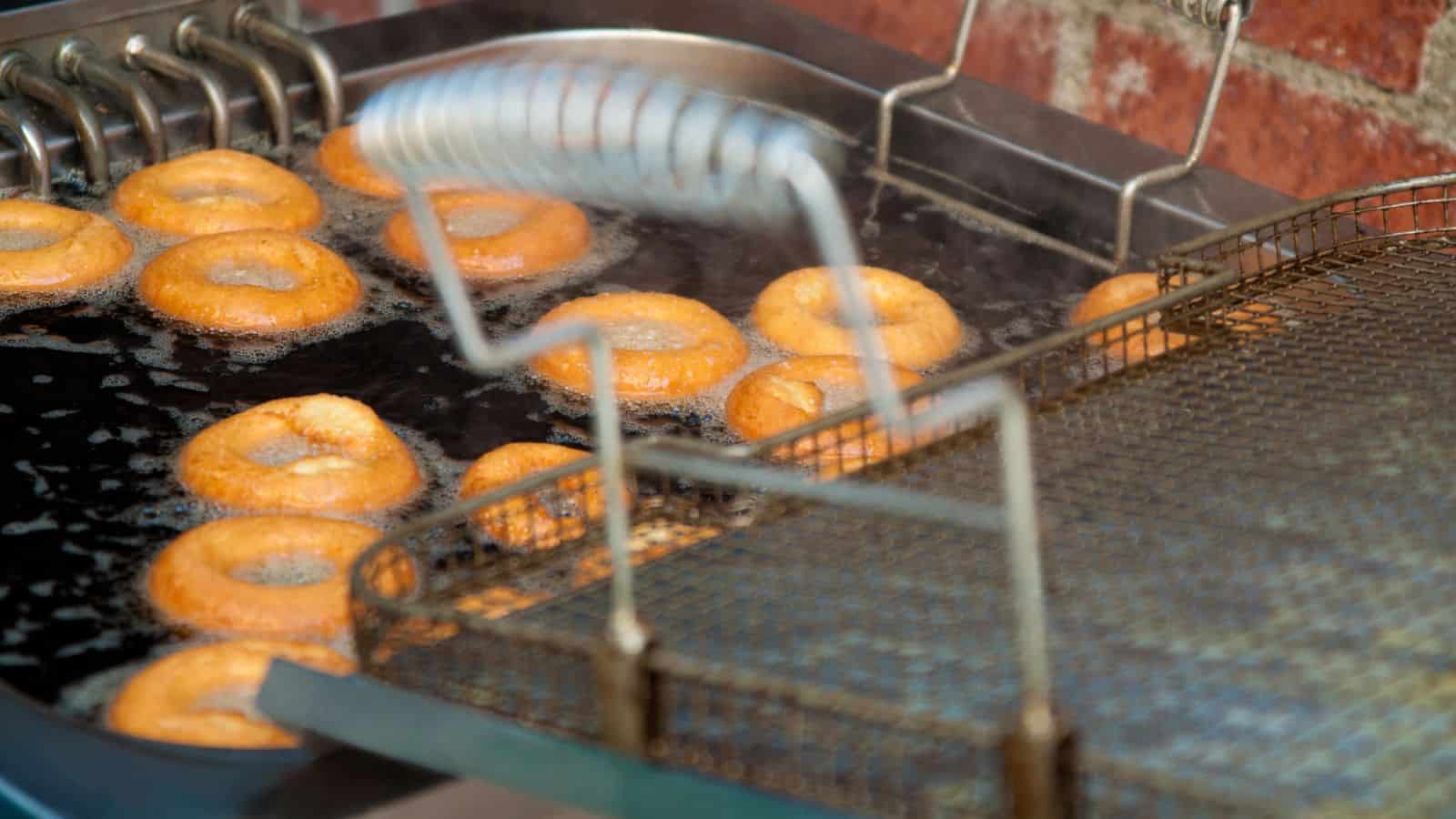 Frying donuts in a deep fryer.