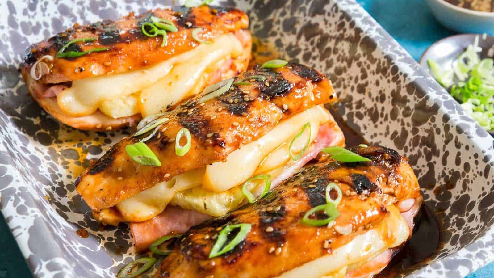 Grilled chicken breasts stuffed with ham, pineapple and Jarlsberg cheese garnished with green onion.