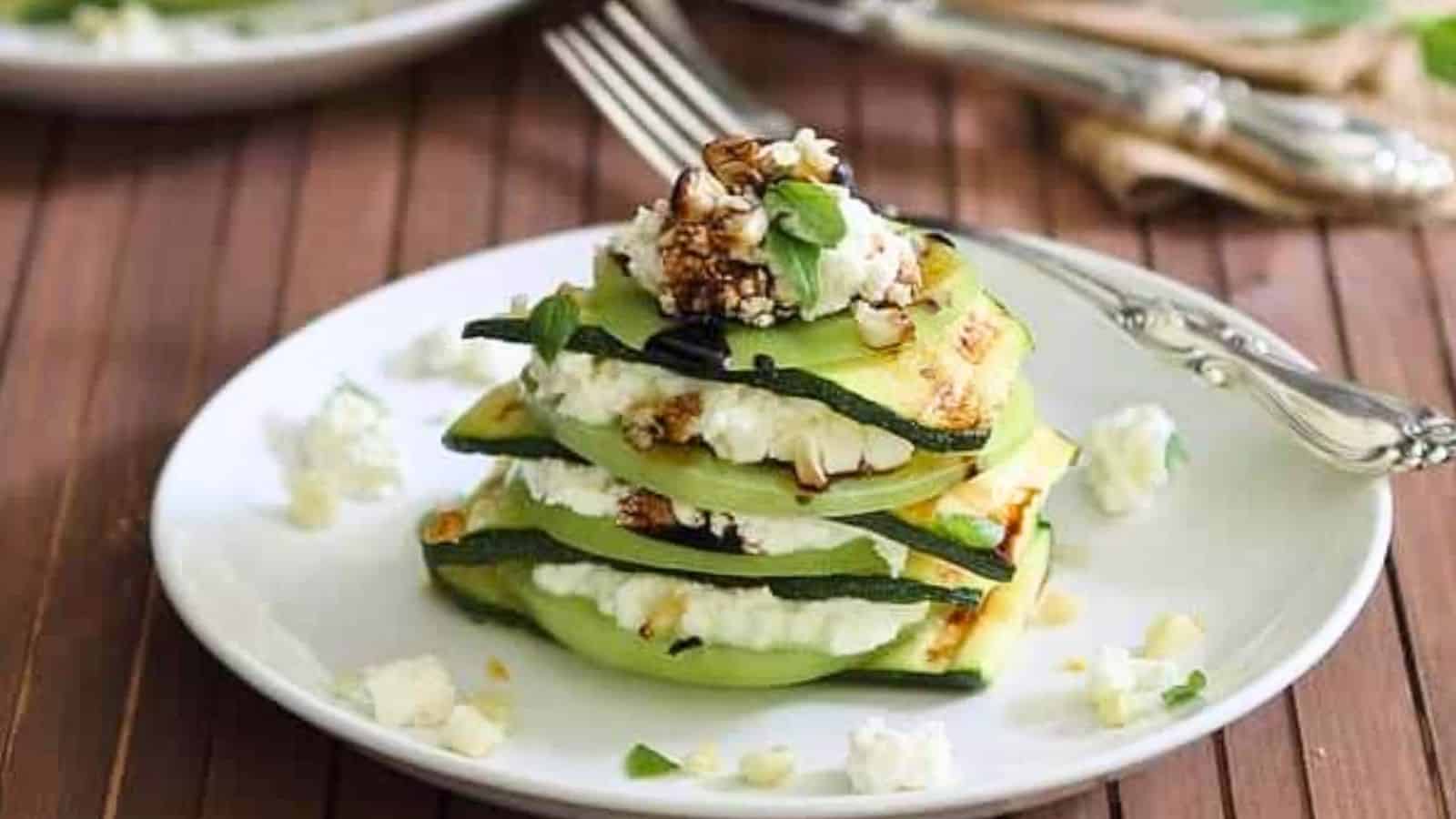 Close-up of grilled zucchini stack in a white plate.