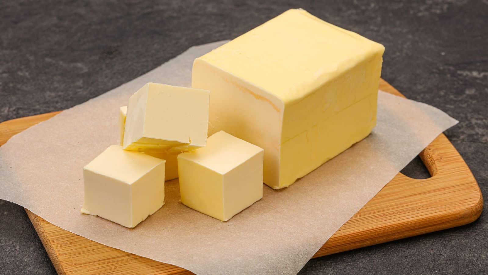 Dairy natural yellow butter piece over board.