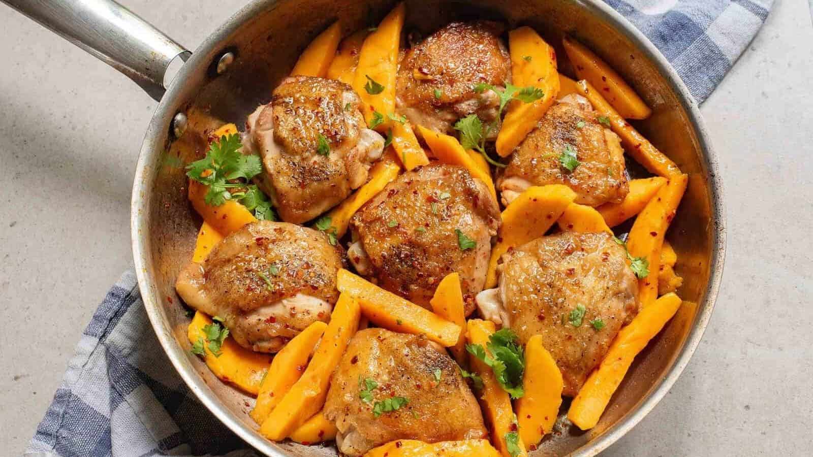 Chicken and mango slices in a pan.