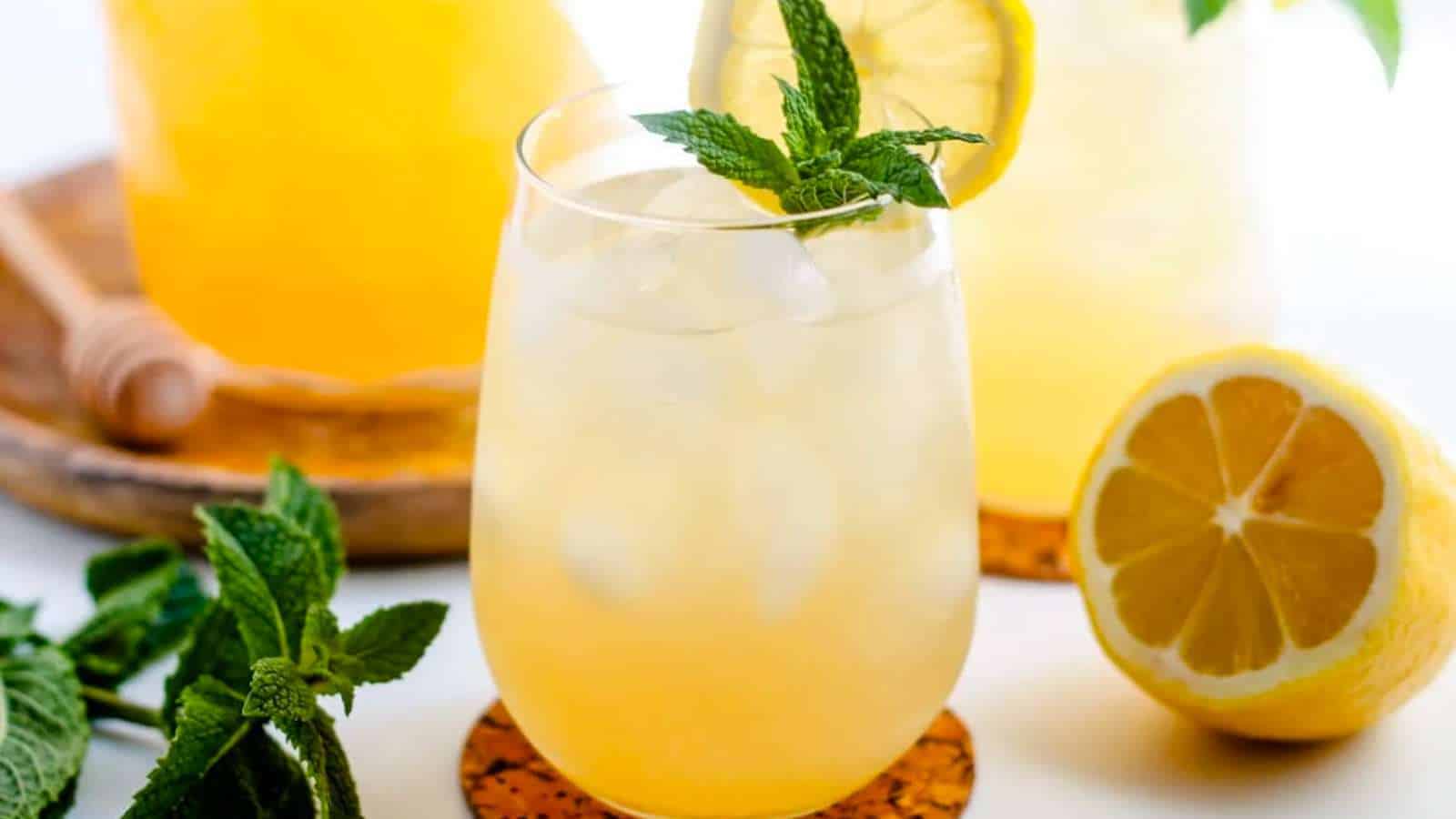 A glass of iced green tea garnished with fresh mint.