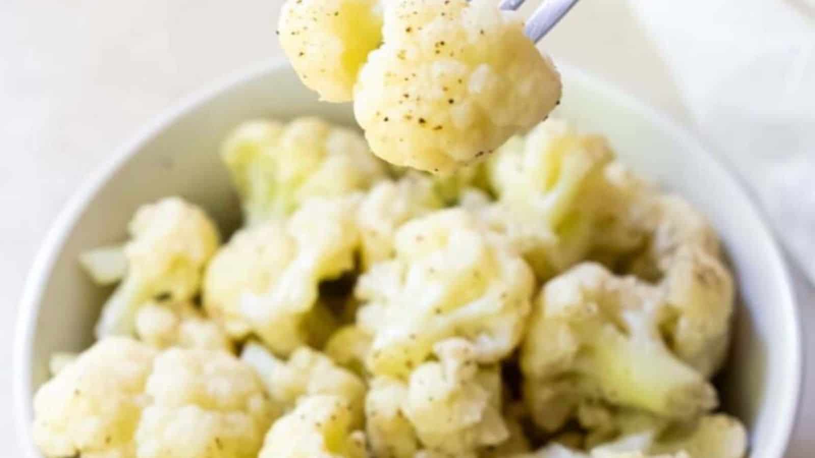 Instant Pot Cauliflower in a white bowl with a fork.