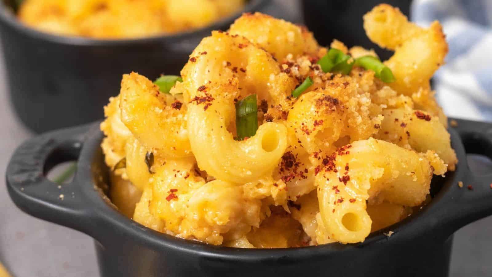 A close up image of kimchi mac and cheese in a cocotte.