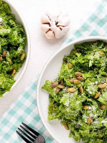 An overhead image of two bowls of lemon garlic kale salad.