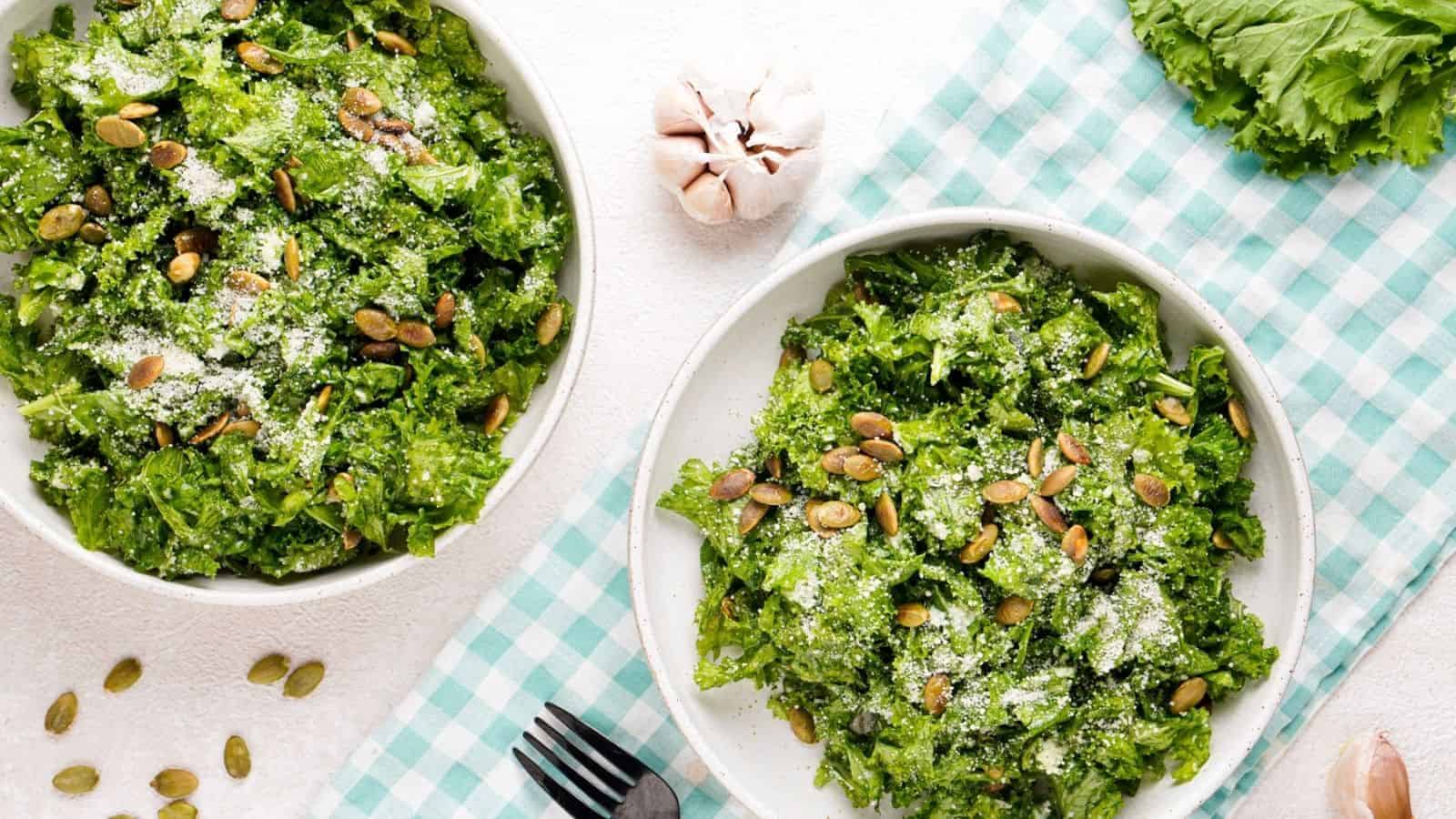 An overhead image of two bowls of lemon garlic kale salad.