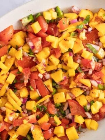 An overhead image of mango salsa in a serving plate.