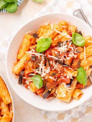 An overhead image of Pasta alla Norma in a bowl with another bowl of pasta on the side.