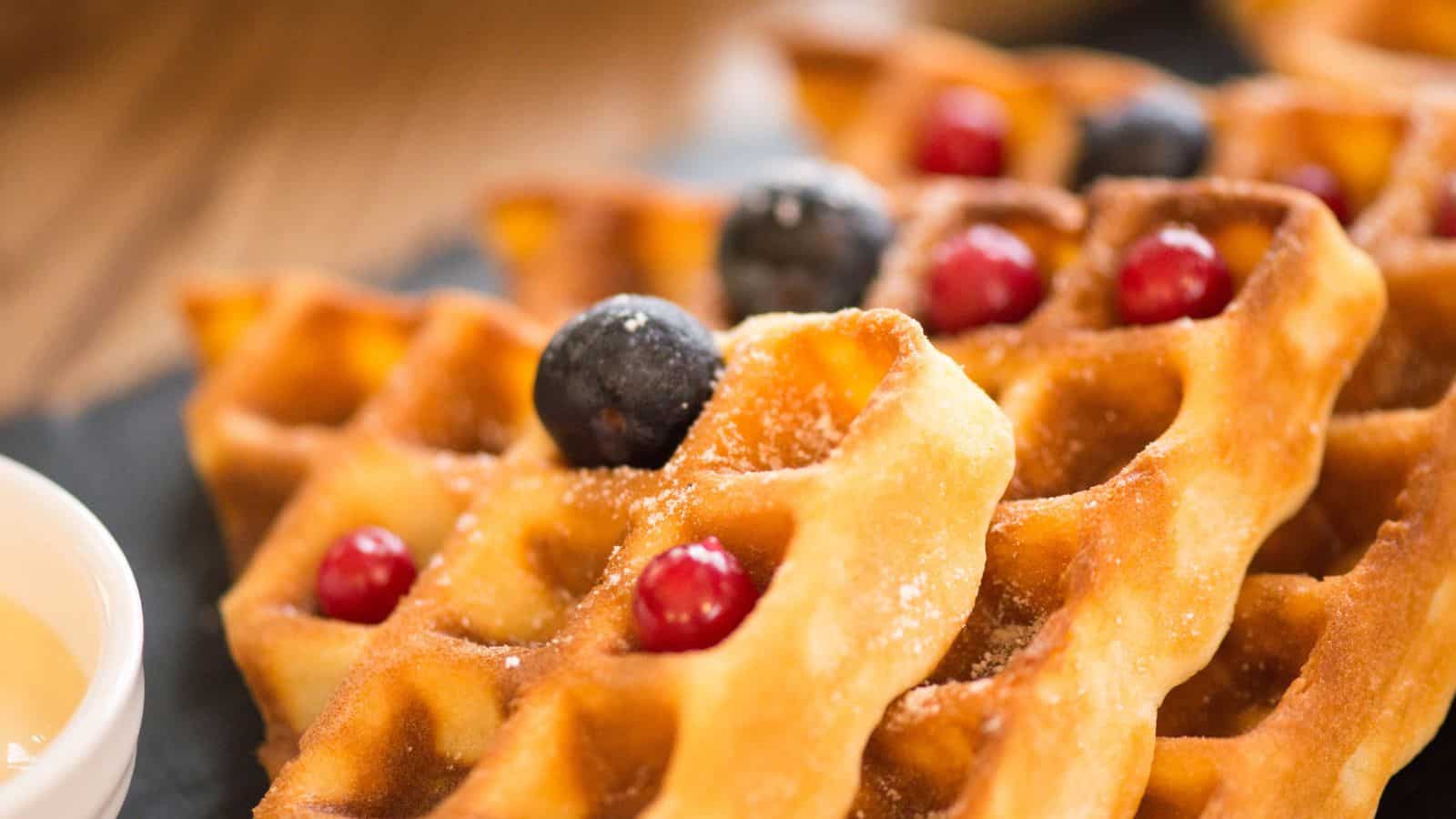 Waffles with vanilla syrup for breakfast with berries.
