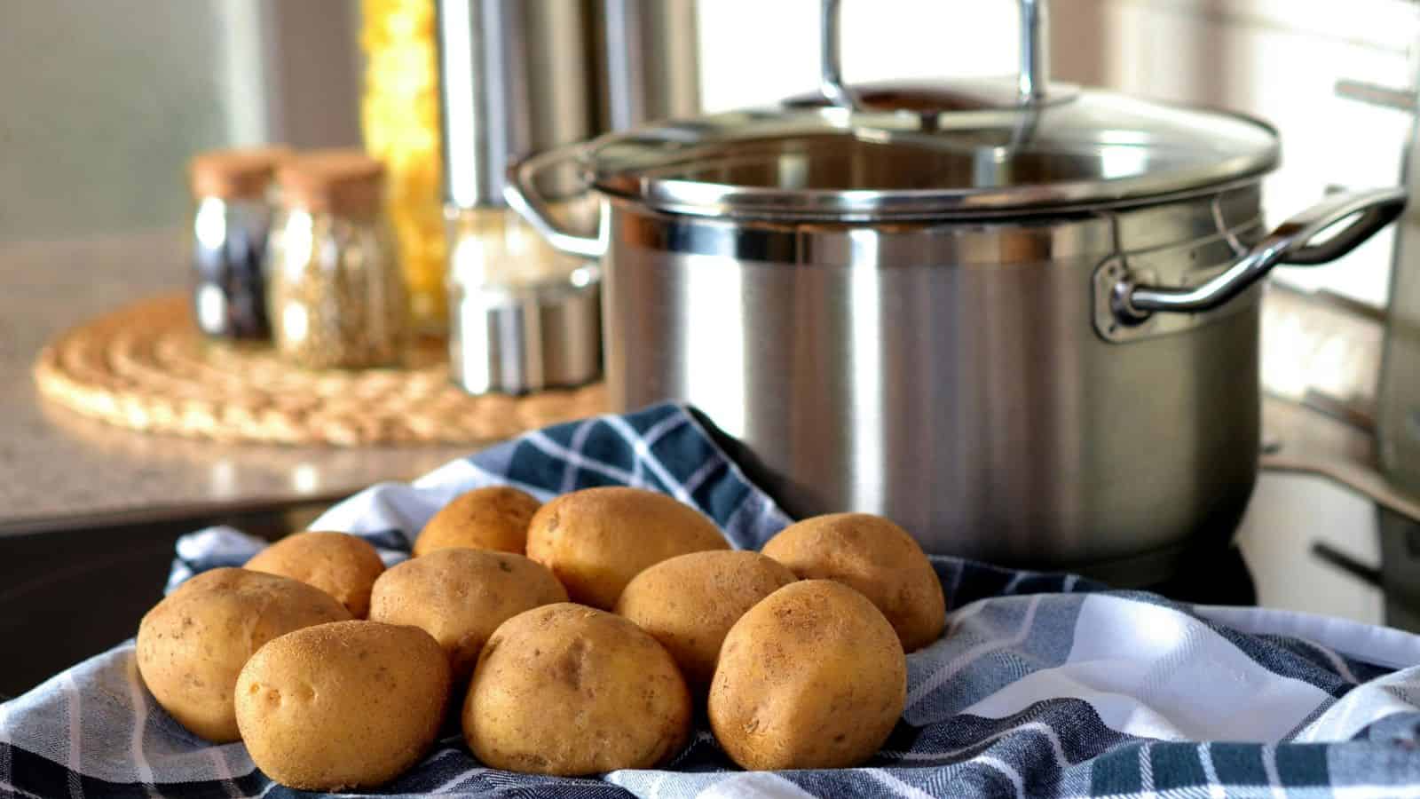Potatoes Beside Stainless Steel Cooking Pot.