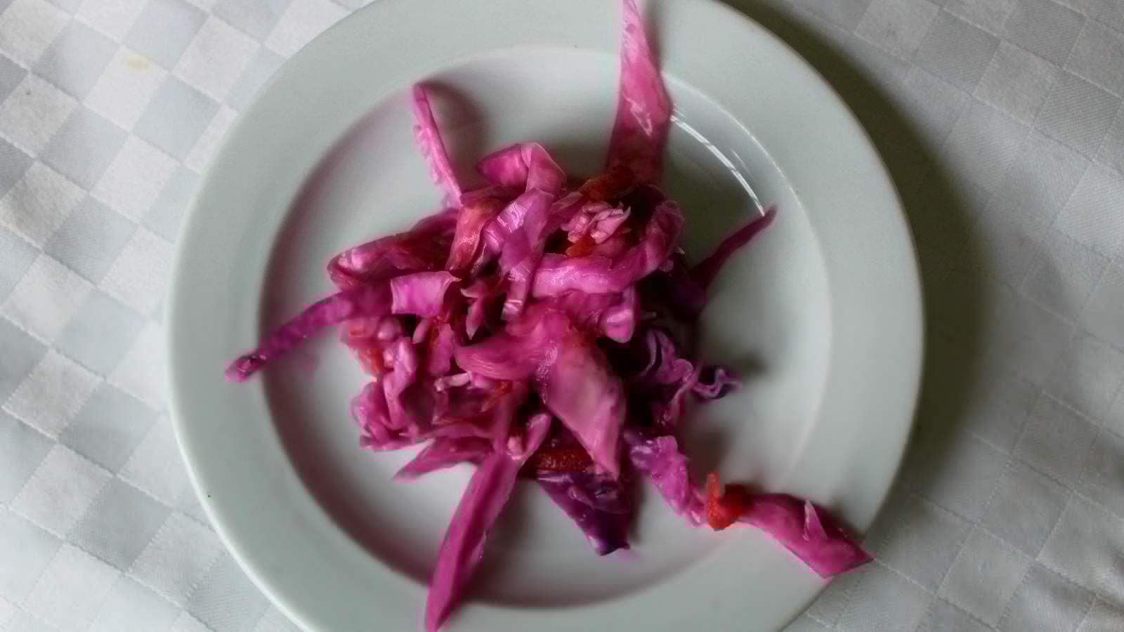 A top view image of quick-pickled russian sauerkraut in a white plate.