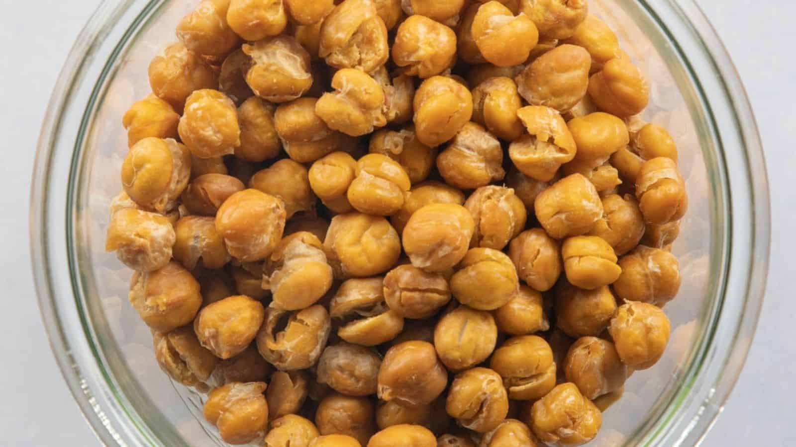 A top-down view of a glass bowl filled with roasted chana.