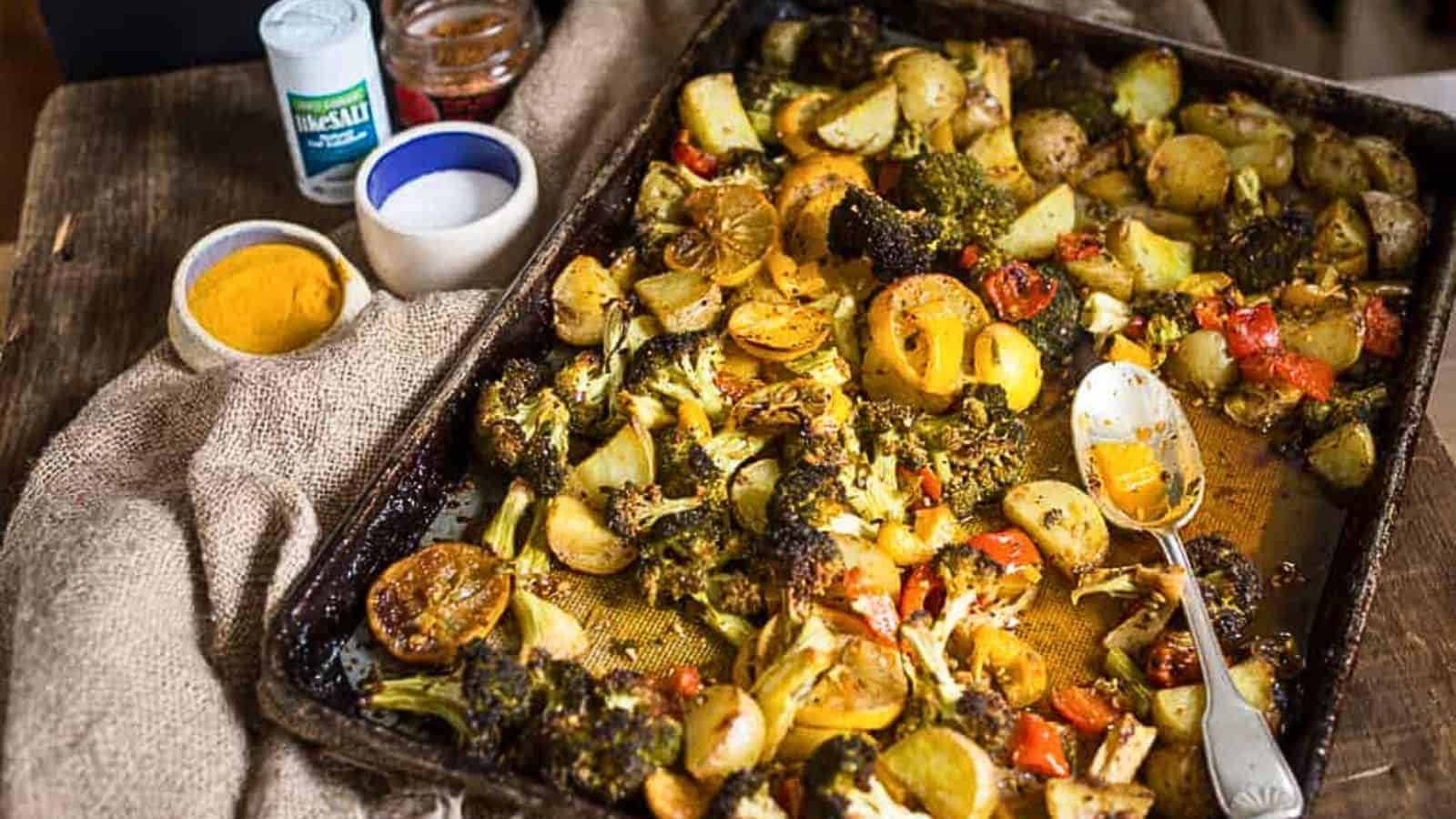 Roasted broccoli, lemon potatoes, and bell peppers in a sheet pan.