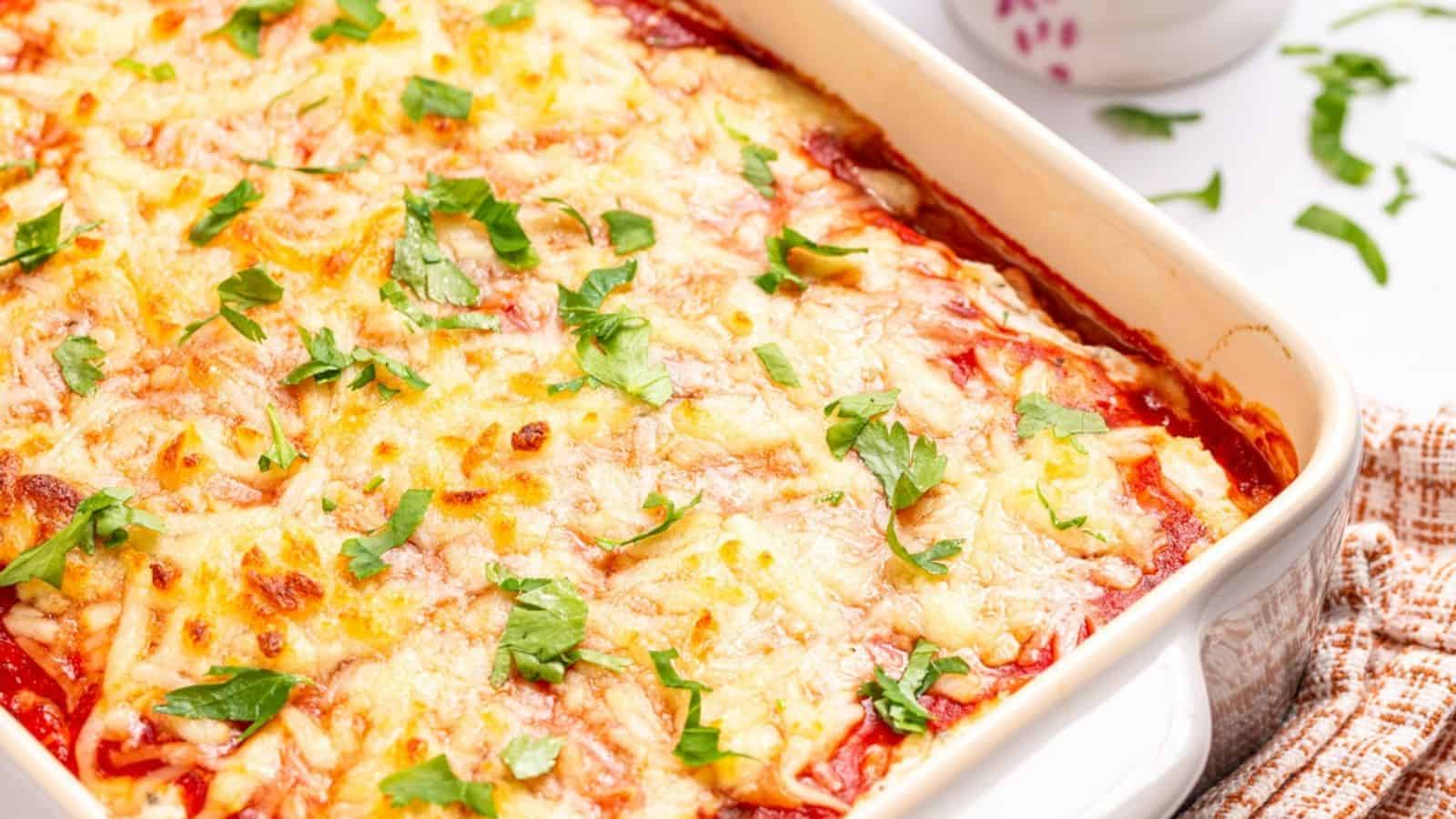 A close up view of spaghetti squash lasagna placed in a baking dish.