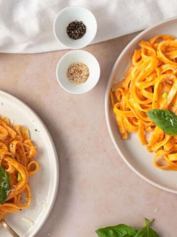 An overhead iimage of two spicy alfredo pasta in a white plate.