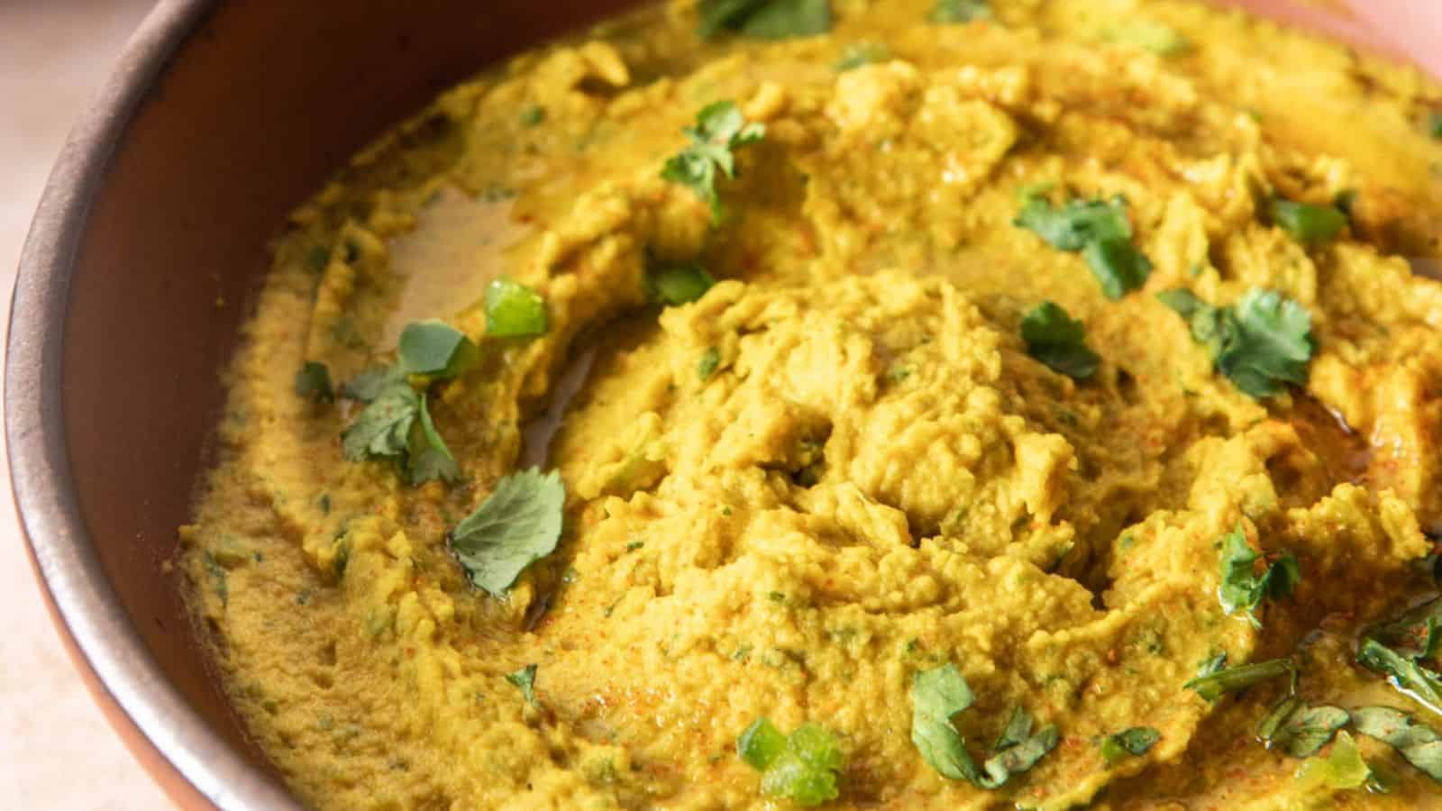 A close up image of spicy chickpea dip in a bowl.