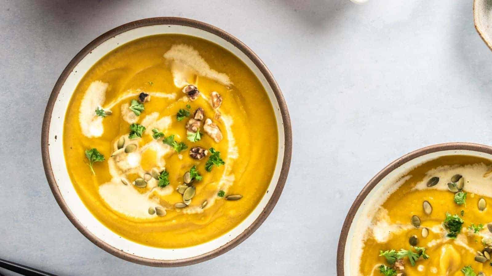 An overhead image of spicy pumpkin soup served in a bowl.