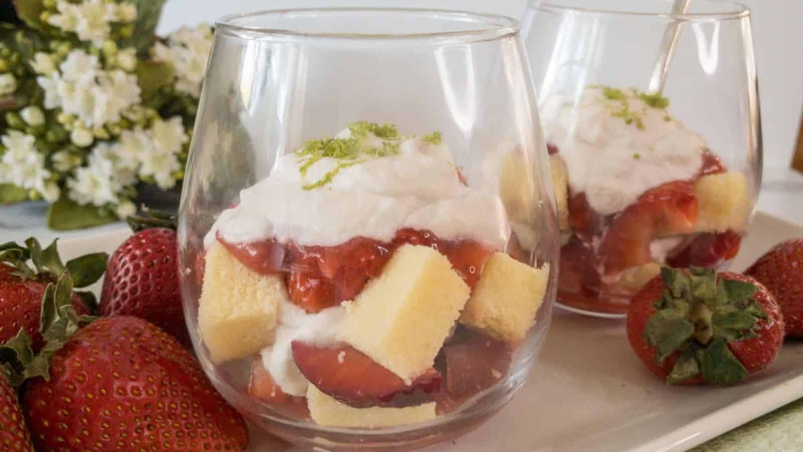 Strawberries, cake and whipped cream layered in dessert glasses.