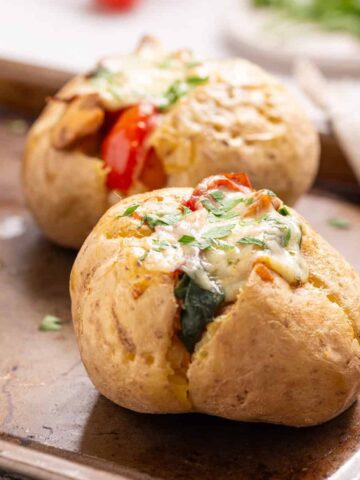 A close-up image of stuffed baked potatoes.