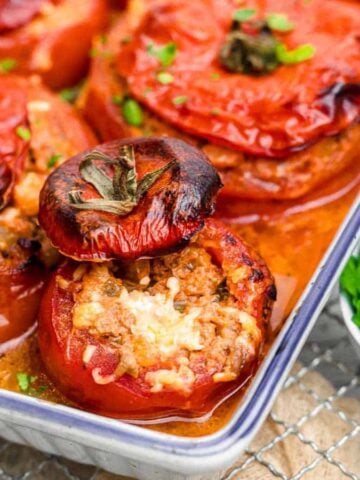 Stuffed Tomatoes inside white casserole.