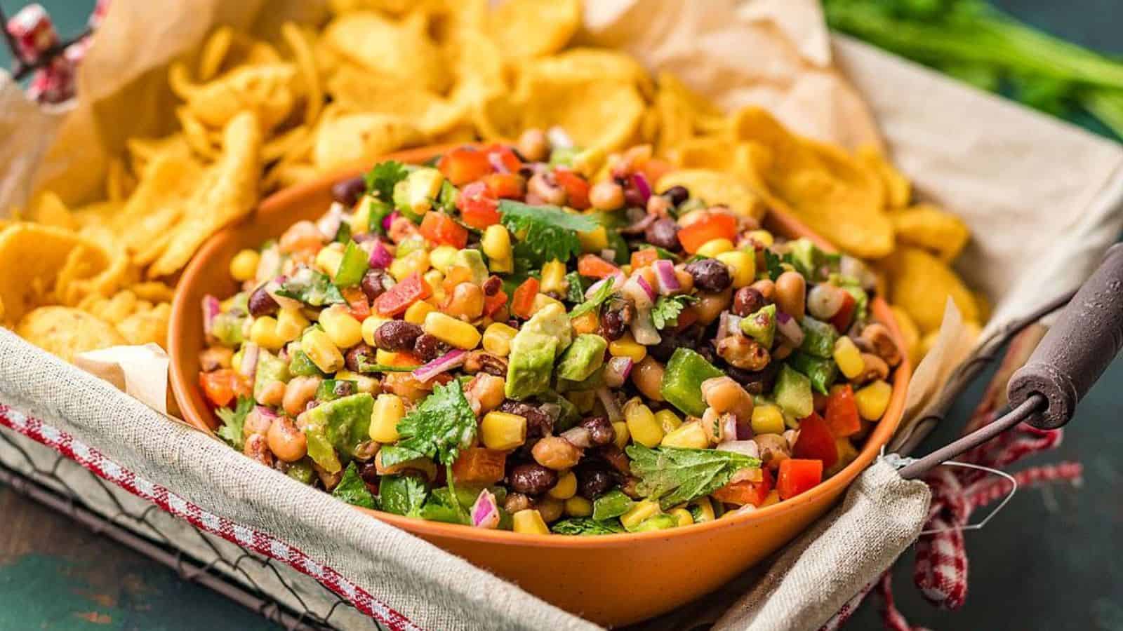 Close-up of Texas cowboy caviar dip in a bowl with chips in the background.