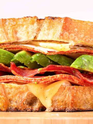 A turkey avocado sandwich sits in the background.