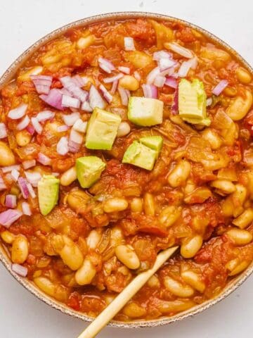 An overhead image of vegan white bean chili with toppings.