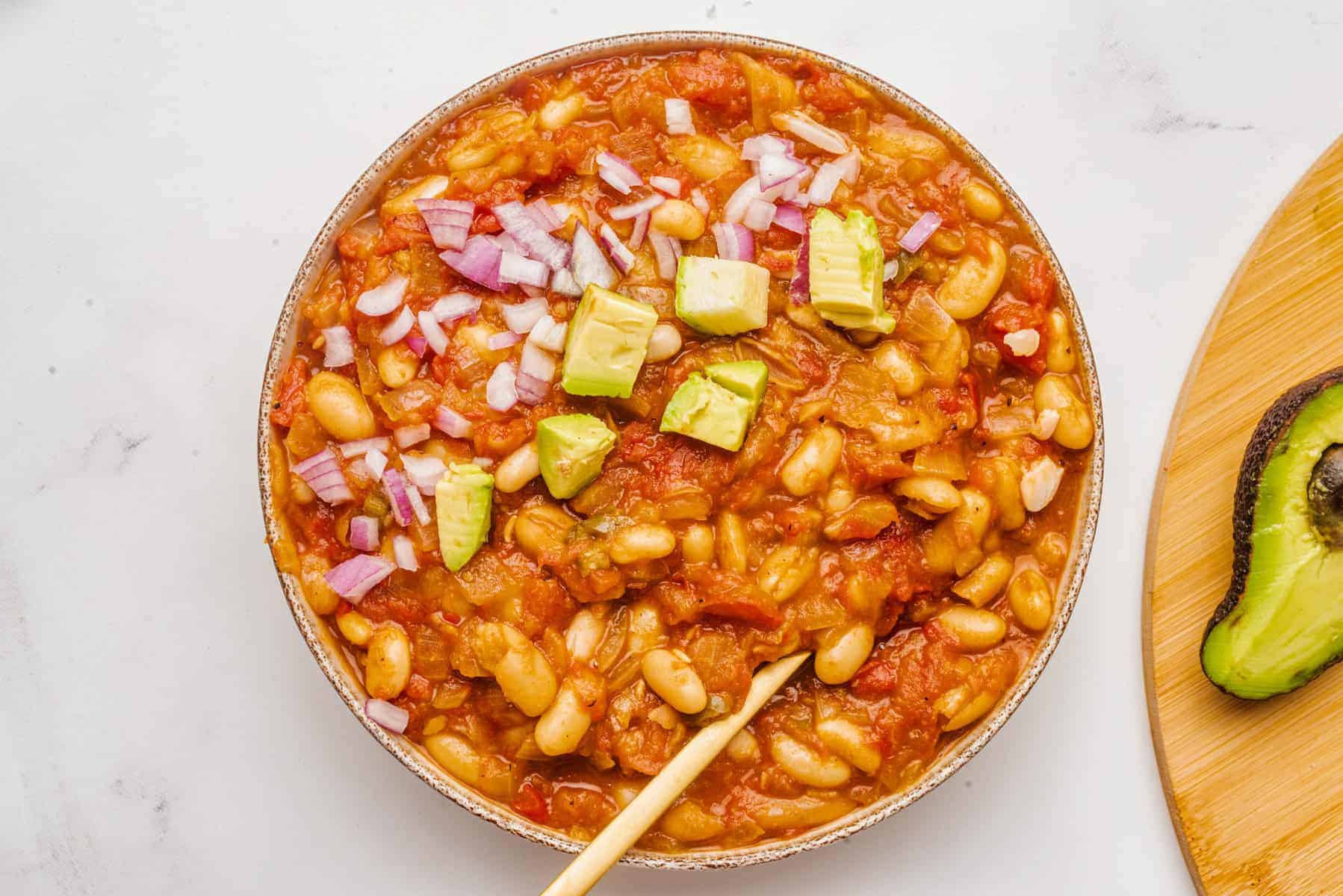 An overhead image of vegan white bean chili with toppings.