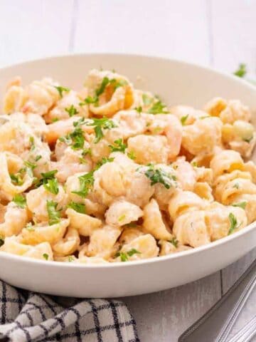 Seafood pasta salad in white serving bowl.