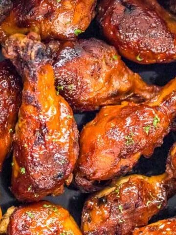 Slow cooker bbq chicken legs in the crock pot after cooking.