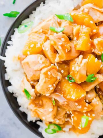 Honey garlic chicken in a bowl served over rice.