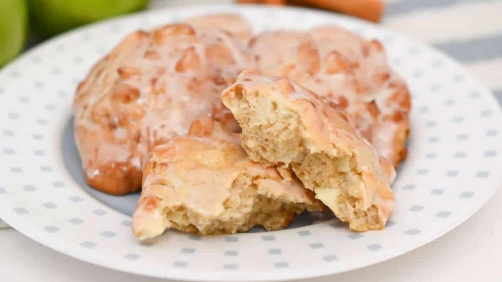 Apple cinnamon fritters on a plate with apples.