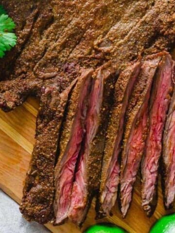Air fryer skirt steak sliced on a cutting board.