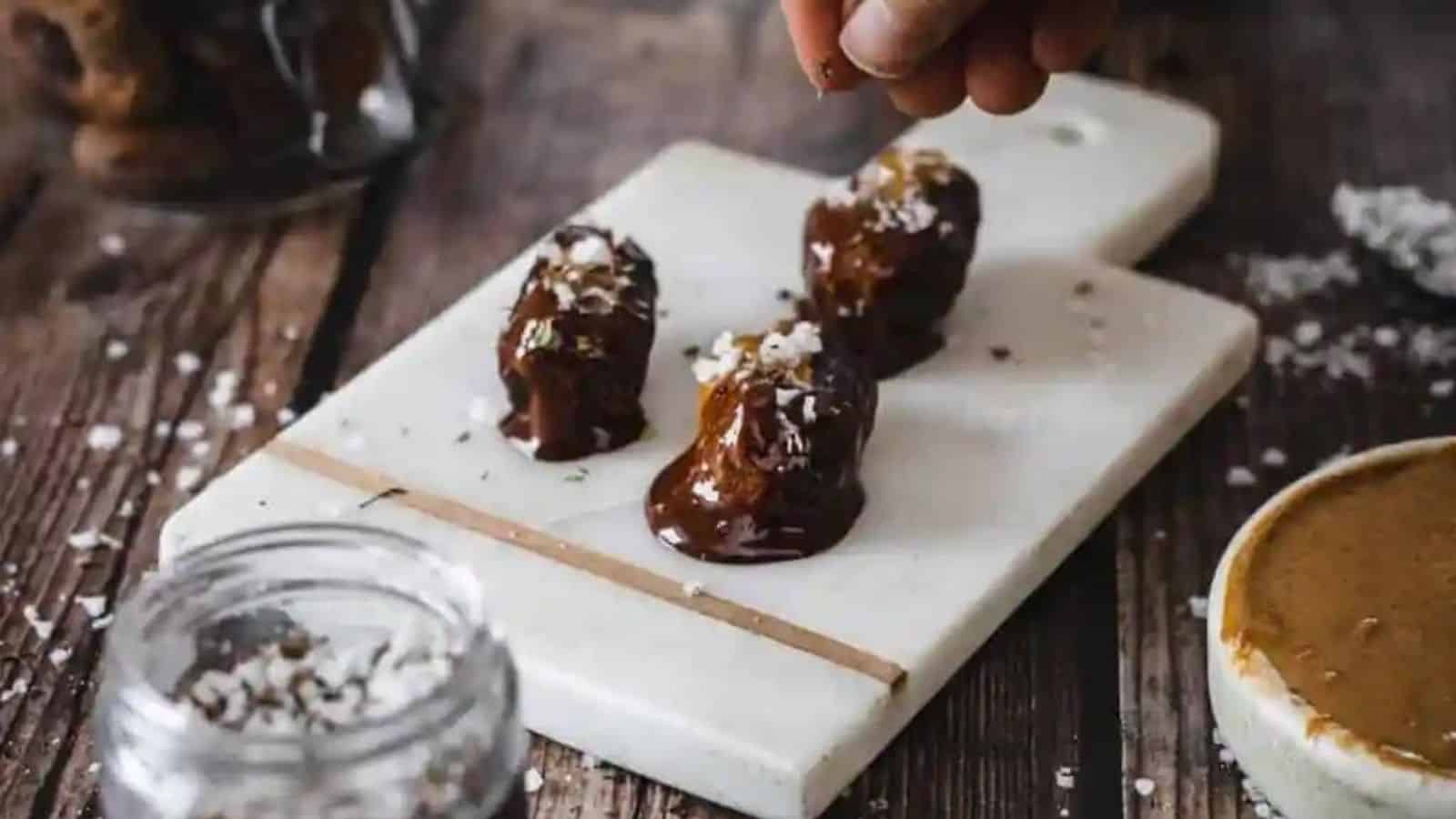 Close-up of almond butter stuffed dates with chocolate.