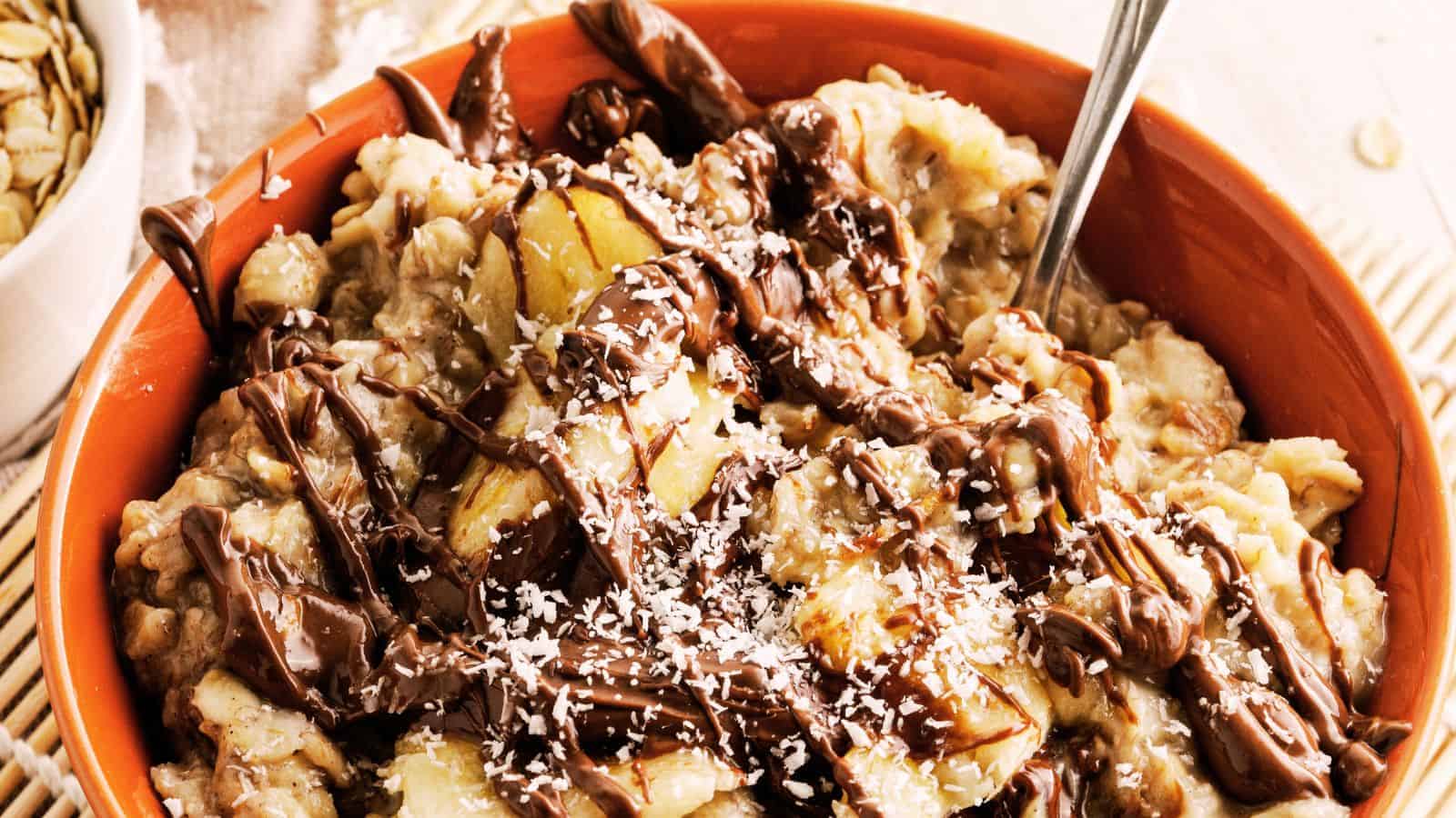 A bowl of banana oatmeal and a glass of milk.